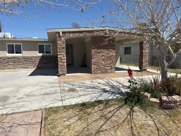 Cozy single-story home featuring stone accents, a covered parking area, and a low-maintenance front yard at 3700 Hickey Ave, North Las Vegas, NV 89030