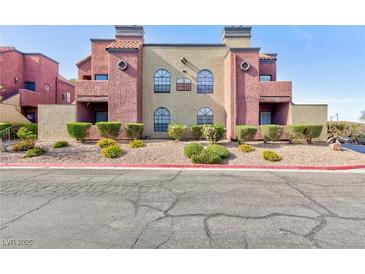 Charming condo building featuring desert landscaping and colorful stucco accents at 4050 Pacific Harbors Dr # 112, Las Vegas, NV 89121
