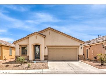 Charming single-story home featuring a low maintenance front yard and attached two car garage at 4071 Blue Manor Ln, North Las Vegas, NV 89032