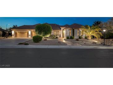 Charming single-story home features a three car garage and a meticulously landscaped front yard with desert landscaping at 5858 Majestic Tide Ave, Las Vegas, NV 89131