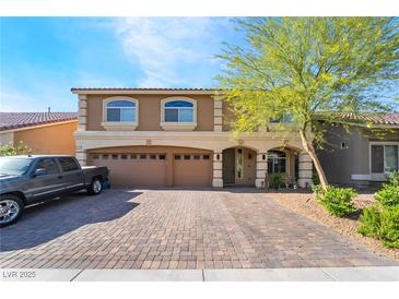 Stunning two-story home featuring a three-car garage and a beautifully paved driveway at 6047 Ancient Peaks Ave, Las Vegas, NV 89141