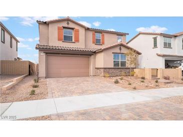 Charming two-story home with a two-car garage and desert landscaping in a residential neighborhood at 789 Black Palace St, Henderson, NV 89011