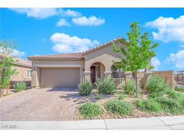 Charming single-story home with a two-car garage, desert landscaping, and a tile roof at 9590 Smiley Creek St, Las Vegas, NV 89178