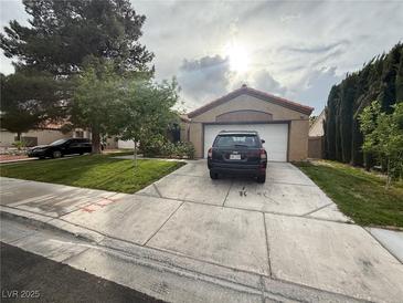 Charming single-story home featuring a well-maintained lawn and an attached two-car garage at , North Las Vegas, NV 89031