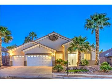 Charming single-story home featuring a three-car garage, desert landscaping, and beautiful curb appeal at 1563 Cattle Ranch Pl, Henderson, NV 89002