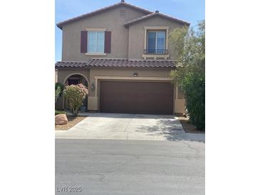Charming two-story home features a well-manicured lawn, two-car garage and traditional architectural details at 5466 Scotch Cap Dr, Las Vegas, NV 89122