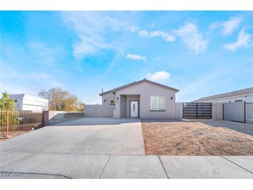 Charming single-story home featuring desert landscaping, a new driveway, and block wall fencing at 60 Pecos St, Las Vegas, NV 89110