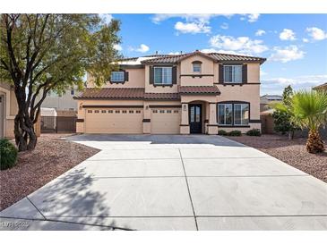 Charming two-story home featuring a three-car garage, landscaped yard, and inviting entrance at 623 Blue Snow River Ct, Henderson, NV 89002