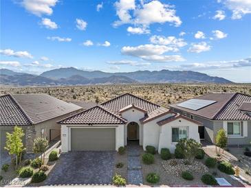 Charming single-story home featuring a desert landscape, paver driveway, and a tile roof at 6557 Corsari Ridge St, Las Vegas, NV 89166