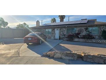 Charming single-story home featuring stone facade, solar panels, and a well-maintained front yard at 6624 Brandywine Way, Las Vegas, NV 89107