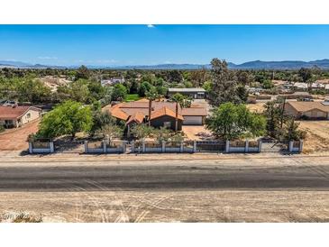 Charming single-story home with a lush landscaped front yard and wrought iron fence at 7760 Haven St, Las Vegas, NV 89123
