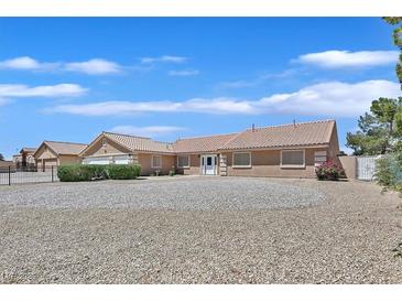 Spacious ranch-style home with desert landscaping, featuring a long, gated driveway at 7925 Placid St, Las Vegas, NV 89123