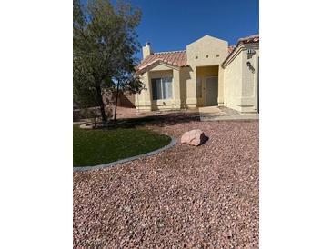 Well-maintained front yard features desert landscaping and a small, neat patch of green grass at 807 Airy Hill St, Henderson, NV 89015