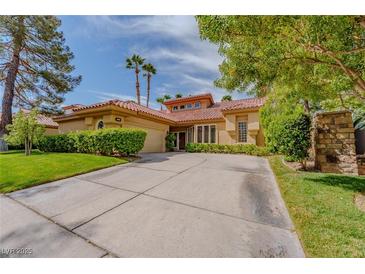 Inviting single-story home with well-manicured landscaping and a spacious driveway at 8199 Pinnacle Peak Ave, Las Vegas, NV 89113