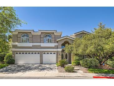 Charming two-story home with a three-car garage, mature trees and arched windows at 1925 Grey Eagle St, Henderson, NV 89074