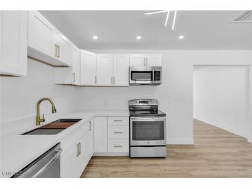 Bright kitchen features white cabinetry, stainless appliances, and quartz countertops at 2105 Berkley Ave, Las Vegas, NV 89101