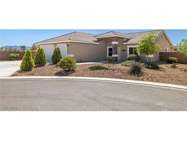 Charming single-story home featuring desert landscaping, a tile roof, and an attached two-car garage at 230 S Weeping Willow Ct, Pahrump, NV 89048
