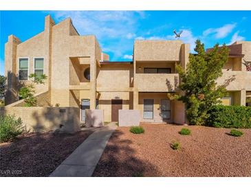 Tan two story townhome featuring a well maintained landscape and inviting entrance, perfect for a new Gathering at 3937 S Torrey Pines Dr, Las Vegas, NV 89103