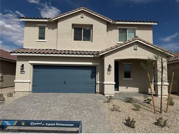 Charming two-story home with a blue garage door and a well-maintained, low-water front yard at 4388 Cave Lake Ave, North Las Vegas, NV 89032
