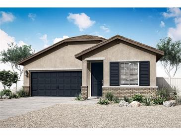 Charming single-story home with a two-car garage, neutral stucco, rock landscaping and a covered front porch at 4392 Cave Lake Ave, North Las Vegas, NV 89032