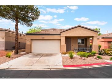 Charming single-story home featuring a two-car garage and desert landscaping at 601 Bear Grass St, Las Vegas, NV 89144
