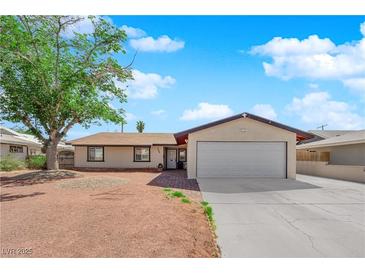Charming single-story home with a spacious two-car garage and mature shade tree in front at 608 W Mcdermit St, Las Vegas, NV 89107