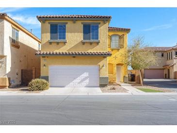 Charming yellow two-story home with a two-car garage and beautiful curb appeal at 648 Sumatra Pl, Henderson, NV 89011