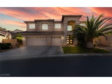 Attractive two-story home featuring a three-car garage and a well-maintained front yard at 695 Orbiter Ln, Las Vegas, NV 89148