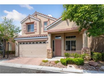 Charming two-story home with a well-maintained front yard and a two car garage at 7589 Grassy Bank St, Las Vegas, NV 89139