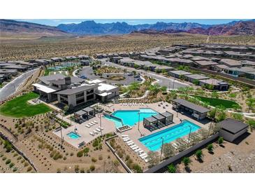Stunning aerial view of resort-style pool and community amenities with mountain views in a vibrant residential area at 897 Woodburn Ln, Las Vegas, NV 89138