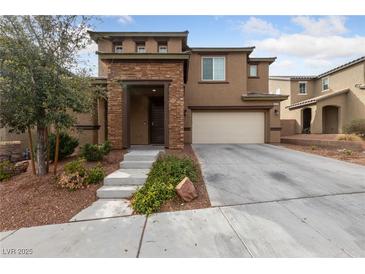 Charming two-story home featuring a stone accented entrance, desert landscaping, and a two car garage at 10373 Northern Hills Ave, Las Vegas, NV 89166