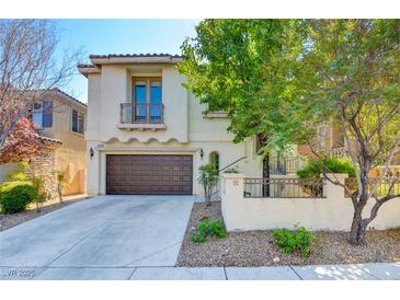 Charming two-story home with a well-manicured front yard and a two-car garage at 11833 Amistoso Ln, Las Vegas, NV 89138