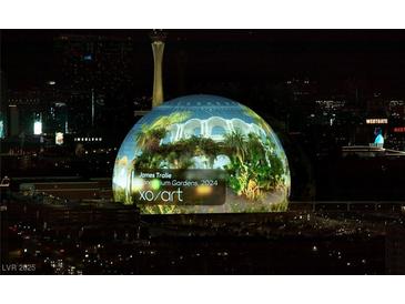 A digital dome is displaying a garden inside, surrounded by the night skyline of Las Vegas at 135 E Harmon Ave # 3620, Las Vegas, NV 89109