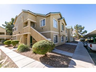 Inviting exterior showcasing a well-maintained two-story apartment building with beautiful landscaping and convenient parking spaces at 1550 Jamielinn Ln # 102, Las Vegas, NV 89110