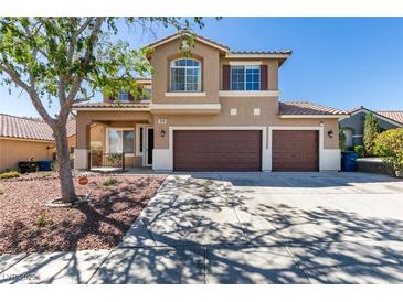 Inviting two-story home featuring a three-car garage and desert landscaping at 189 Regal Sunset Ave, Henderson, NV 89002
