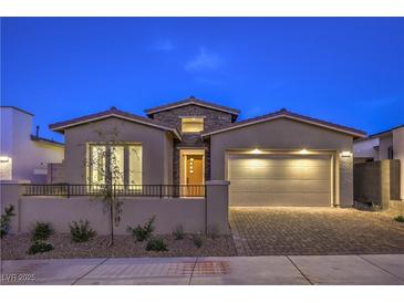 Charming single-story home with a brick driveway and a well-manicured front yard at 2194 Pigeon Hawk St, Las Vegas, NV 89138