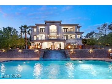 An opulent residence with a stunning pool and waterfall feature provides a luxurious outdoor experience at 22 Anthem Pointe Ct, Henderson, NV 89052