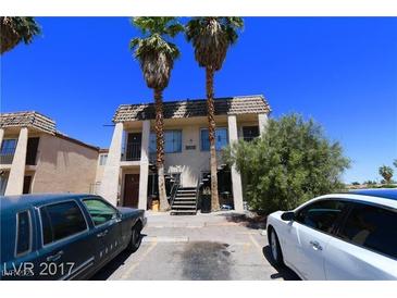 Two-story apartment complex with palm trees in front and two parking cars at 3616 Thomas Ave, North Las Vegas, NV 89030