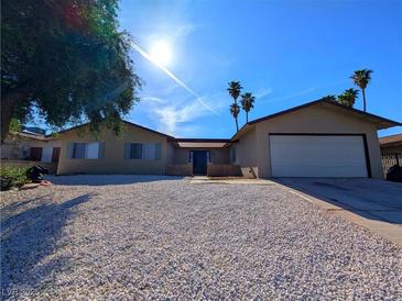 Charming single-story home with a low-maintenance gravel front yard, desert landscaping and attached garage at 3667 Descanso St, Las Vegas, NV 89121
