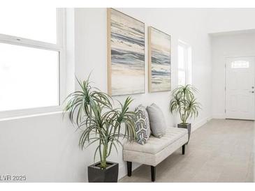 Inviting entryway featuring a bench, plants, and modern art for a stylish first impression at 3915 Wesvan Ct, Las Vegas, NV 89121