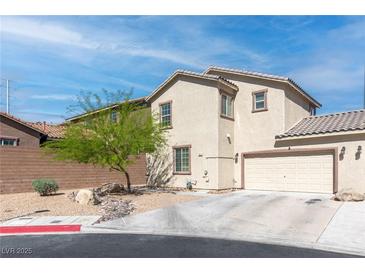 Inviting two-story home featuring a two-car garage, stucco facade, and xeriscaped front yard at 4014 Sparrow Rock St, Las Vegas, NV 89129