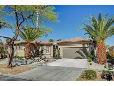 Single-story home featuring desert landscaping, concrete driveway, and a two car garage at 4574 Fiore Bella Blvd, Las Vegas, NV 89135