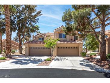 Charming two-story home featuring a spacious three-car garage and a beautifully landscaped front yard with mature trees at 5329 La Patera Ln, Las Vegas, NV 89149