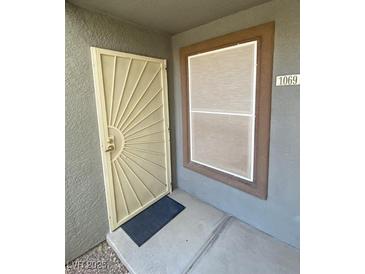 Apartment entry featuring decorative security door, screen and address number at 555 E Silverado Ranch Blvd # 1069, Las Vegas, NV 89183