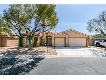Charming single-story home with a well-manicured front yard and a two-car garage at 8404 Dripping Rock Ct, Las Vegas, NV 89131