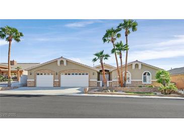 Charming single-story home with a three-car garage and well-maintained landscaping, including palm trees at 904 Rhyolite Ter, Henderson, NV 89011