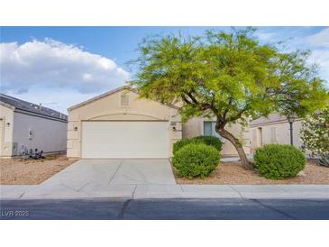 Charming single-story home featuring a two-car garage, desert landscaping, and mature shade tree at , Las Vegas, NV 89130