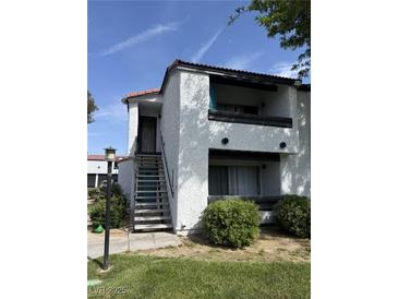 Charming two-story condo features a private balcony and well-maintained landscaping at 1455 E Katie Ave # L23, Las Vegas, NV 89119