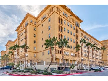 Elegant multi-story building showcasing its architectural design, landscaping, and surrounding palm trees at 2405 W Serene Ave # 703, Las Vegas, NV 89123