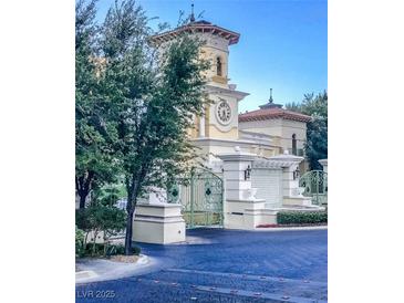 Elegant gated estate featuring a clock tower, lush landscaping, and architectural details at 2877 Paradise Rd # 1806, Las Vegas, NV 89109